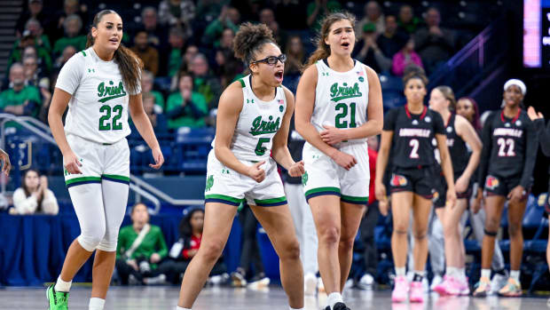 Notre Dame Fighting Irish women's basketball players celebrate after a play.