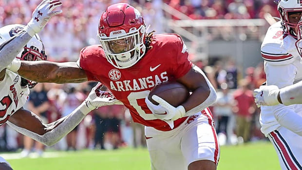 Arkansas running back AJ Green creates space for himself up the middle with a stiff-arm during a 31-24 win over South Carolina in 2022.