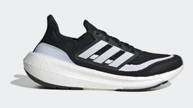 Side view of a black and white adidas running shoe.