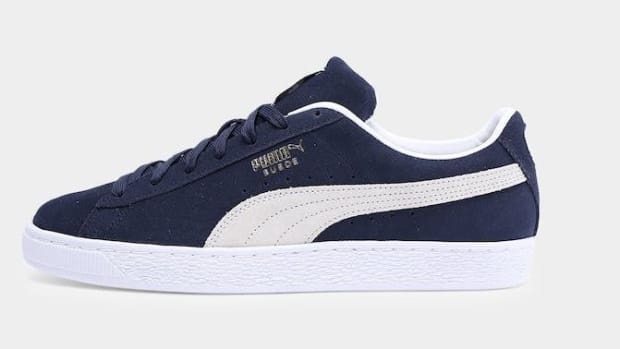 Side view of a navy and white PUMA sneaker.