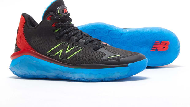 View of black, blue, and red New Balance shoes.