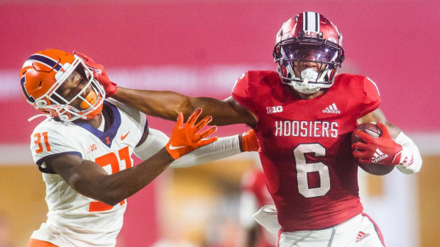 Indiana's Cam Camper (6) stiff arms Illinois' Devon Witherspoon (31) during the Indiana versus Illinois football game at Memorial Stadium on Friday, Sept. 2, 2022.