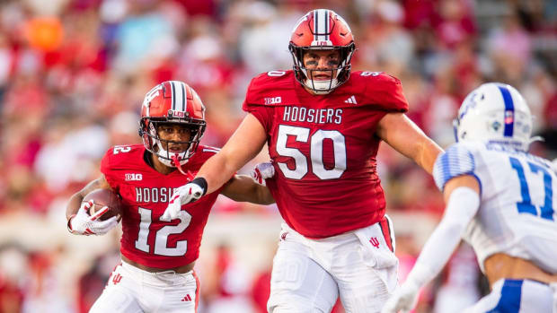 Indiana's Jaylin Lucas (12) runs behind Zach Carpenter (50) during the first half of the Indiana versus Indiana State football game at Memorial Stadium on Friday, Sept. 8, 2023.