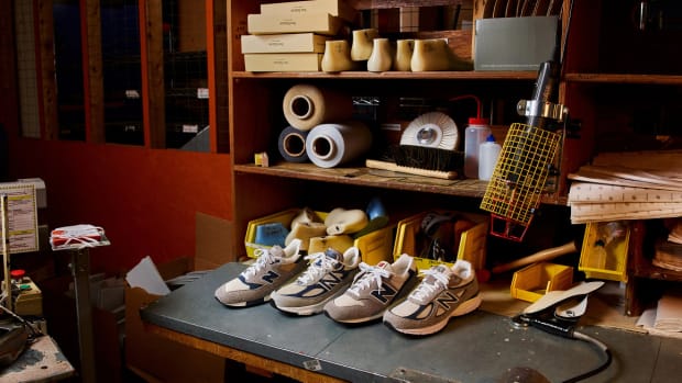 View of four grey New Balance sneakers in a workshop.