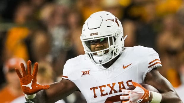 Texas tight end Ja'Tavion Sanders (0) carries the ball as Baylor safety Devin Lemear (20) chases during the third quarter of the Longhorns' game against the Baylor Bears