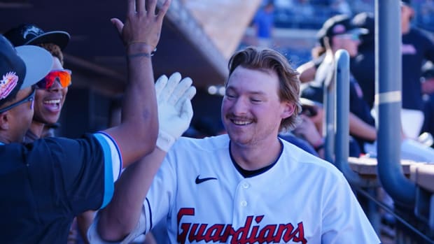 Cleveland Guardians prospect Kyle Manzardo high-fives his teammates.