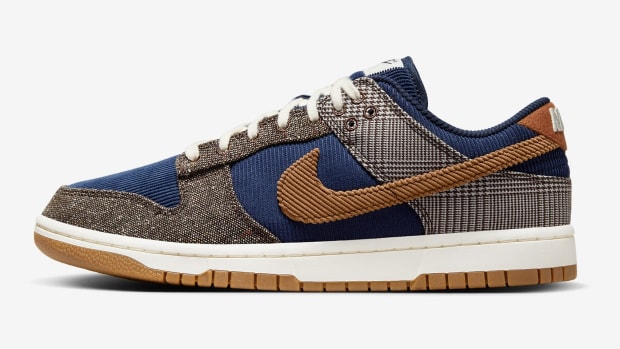 Side view of a blue and brown Nike sneaker.