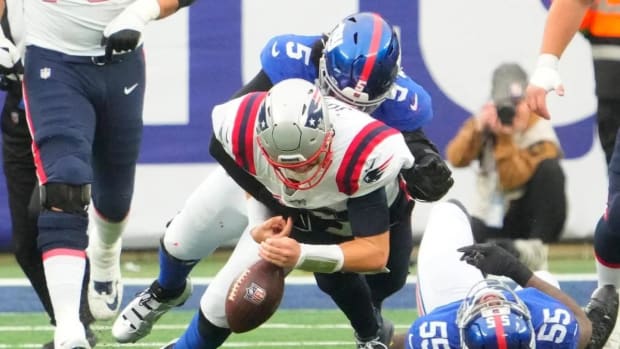 New England Patriots QB Mac Jones loses control of the football against the New York Giants at MetLife Stadium.