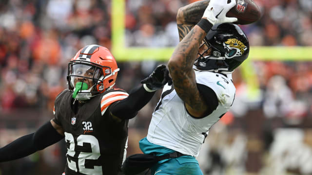 Dec 10, 2023; Cleveland, Ohio, USA; Jacksonville Jaguars tight end Evan Engram (17) catches a pass as Cleveland Browns safety Grant Delpit (22) defends during the first half at Cleveland Browns Stadium.