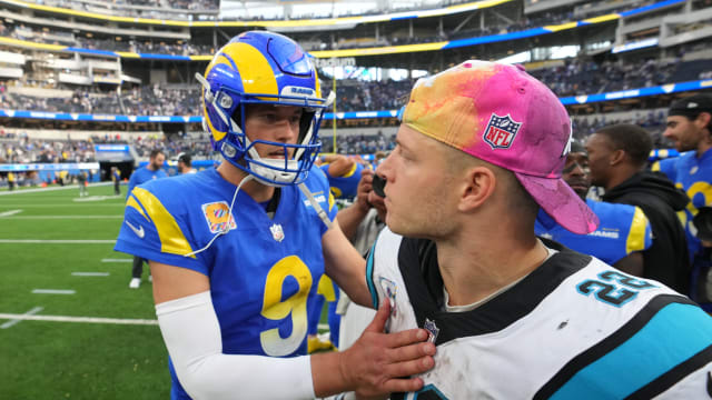 Los Angeles Rams quarterback Matthew Stafford (9) shakes hands with Carolina Panthers running back Christian McCaffrey (22) after the game at SoFi Stadium.