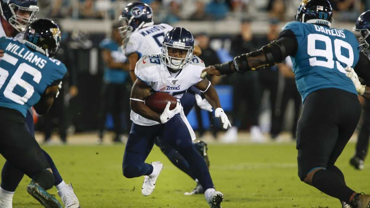 Jacksonville Jaguars linebacker Travon Walker (44) tackles Tennessee Titans  running back Derrick Henry in the second half of an NFL football game,  Saturday, Jan. 7, 2023, in Jacksonville, Fla. (AP Photo/John Raoux