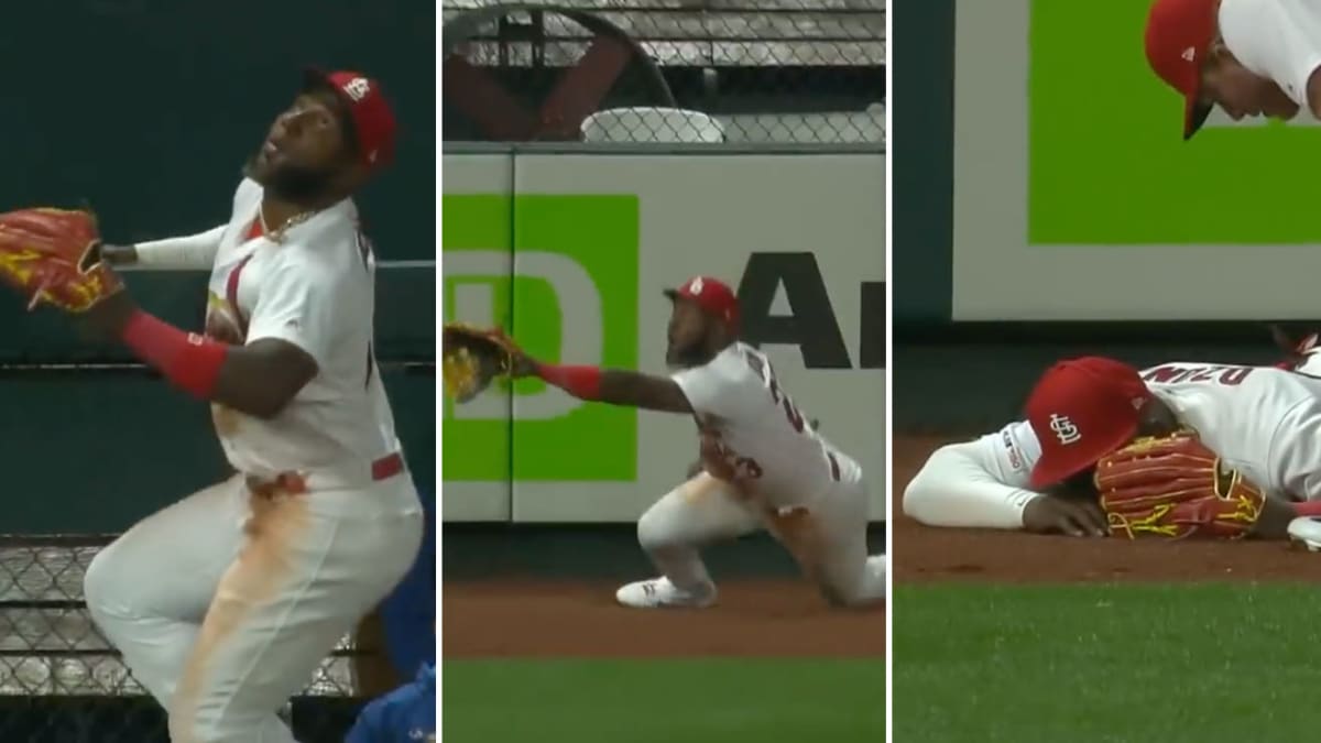 Marcell Ozuna climbs wall