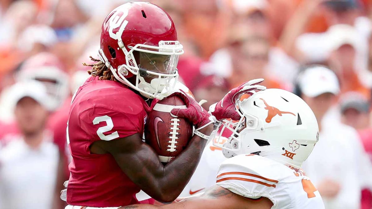 CeeDee Lamb Oklahoma Sooners Unsigned Crimson Jersey Throwing A Pass During 2018 College Football Playoff Semifinal Photograph