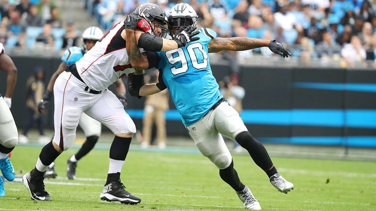 Carolina Panthers coach John Fox, left, helps draft choice Julius