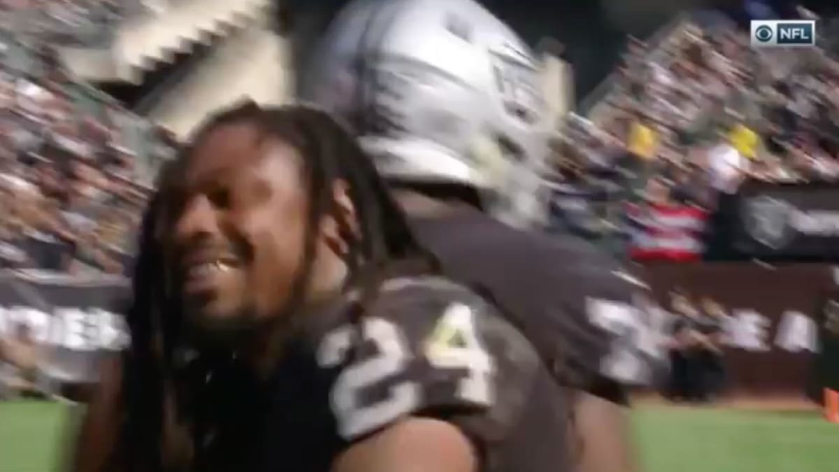 Marshawn Lynch sits during national anthem before NFL return