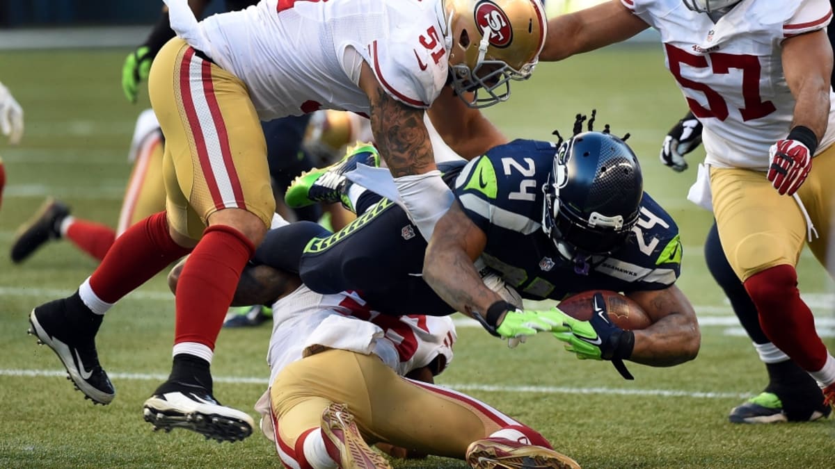 Seattle Seahawks running back Marshawn Lynch (24) dons his gloves during an  injury time out during the NFL Championship Game against the San Francisco  49ers at CenturyLink Field in Seattle, Washington on