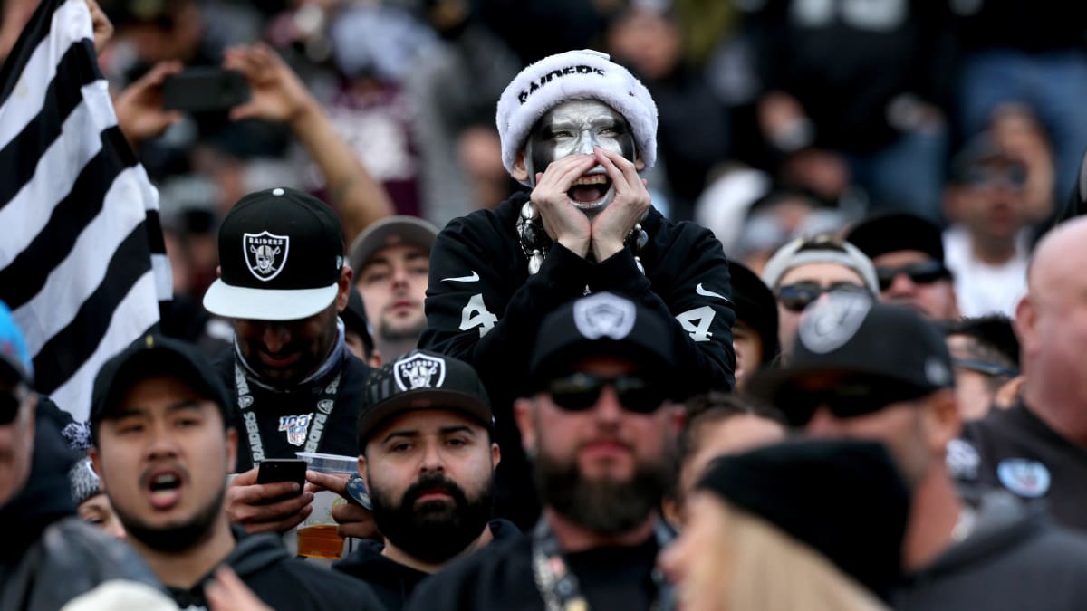 Oakland Raiders fans cheer during an NFL game against the Los