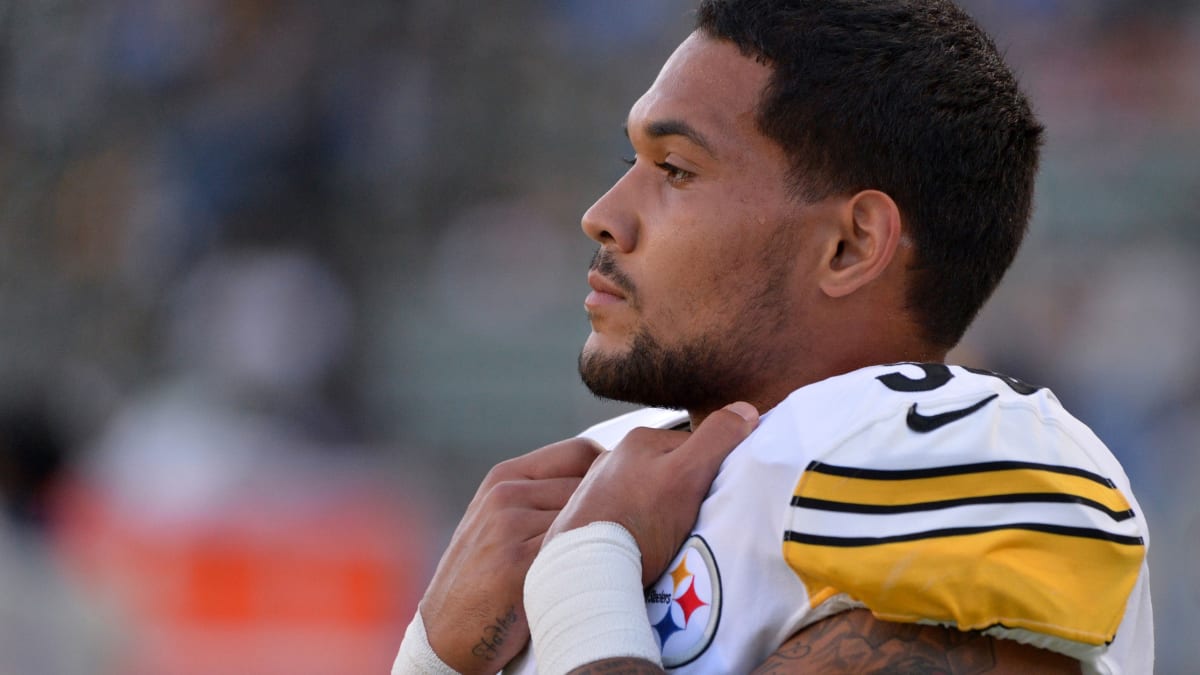 Pittsburgh Steelers running back James Conner (30) shades his eyes as he  watches special team drills