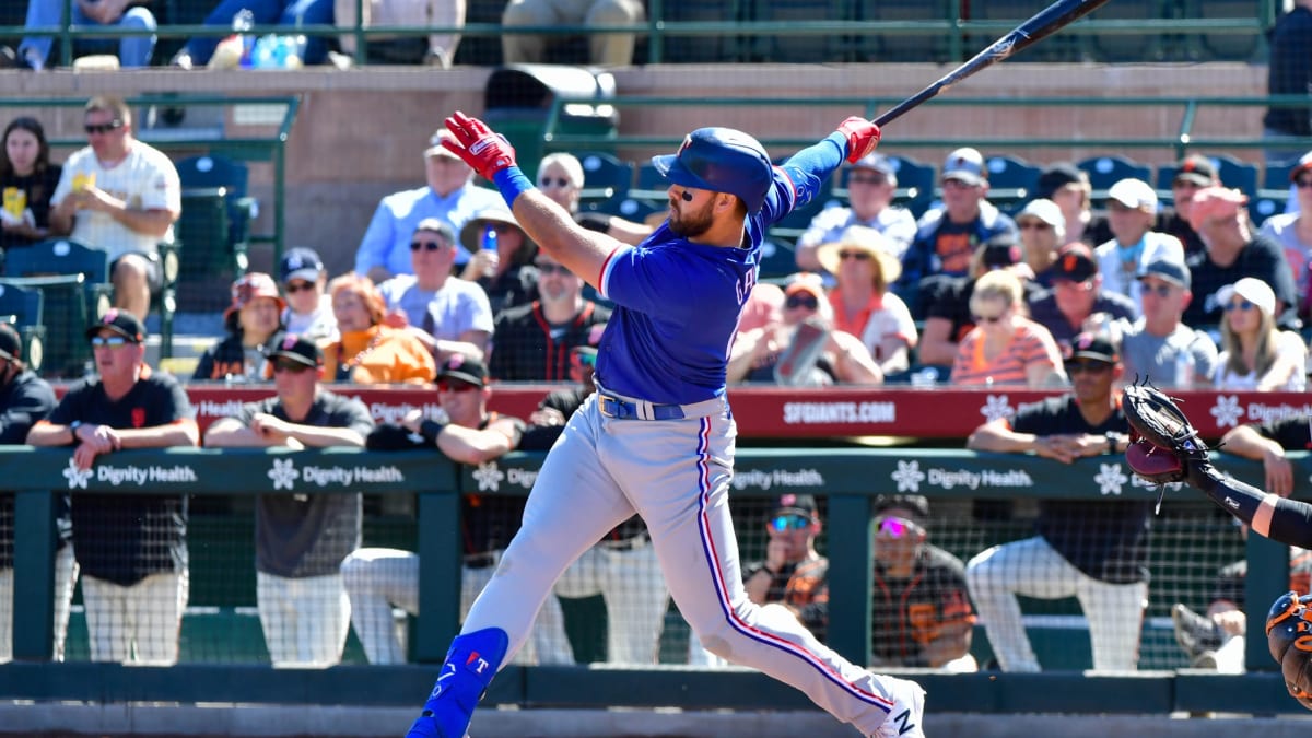 Texas Rangers' Yoshi Tsutsugo watches the flight of a ball that went foul  during the eighth inning of a spring training baseball game against the  Kansas City Royals on Tuesday, March 28