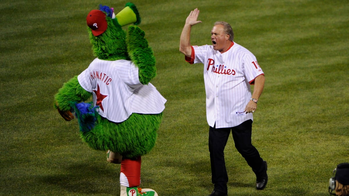 Phillies left fielder Greg Luzinski, center, follows through on a