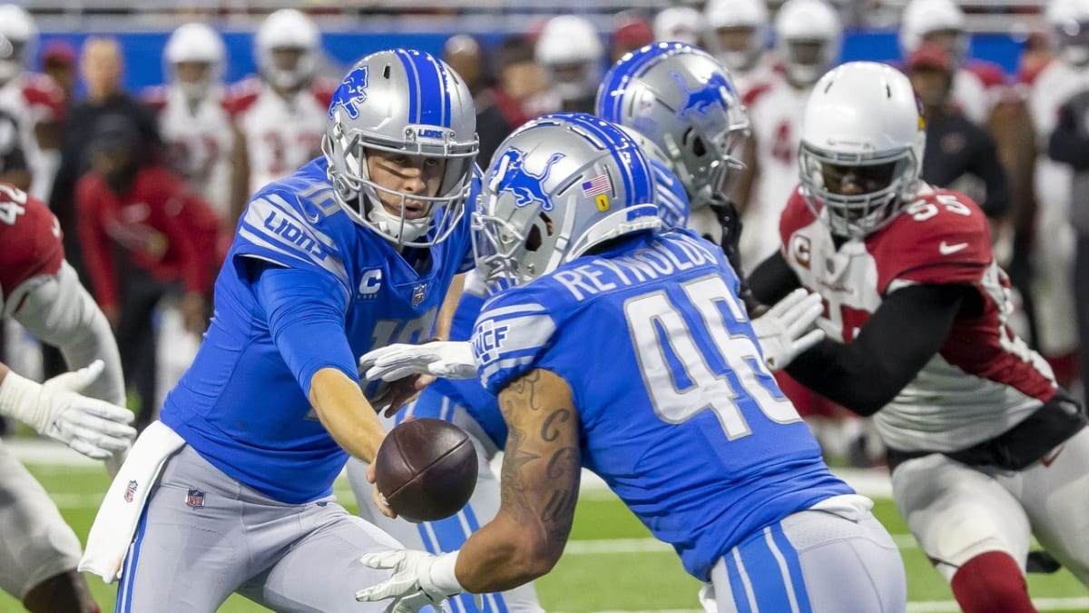 Arizona Cardinals vs. Detroit Lions. NFL Game. American Football League  match. Silhouette of professional player celebrate touch down. Screen in  background. Stock Photo