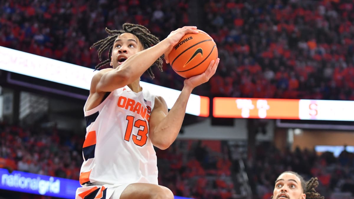 Syracuse forward Benny Williams, right, grabs a rebound in front