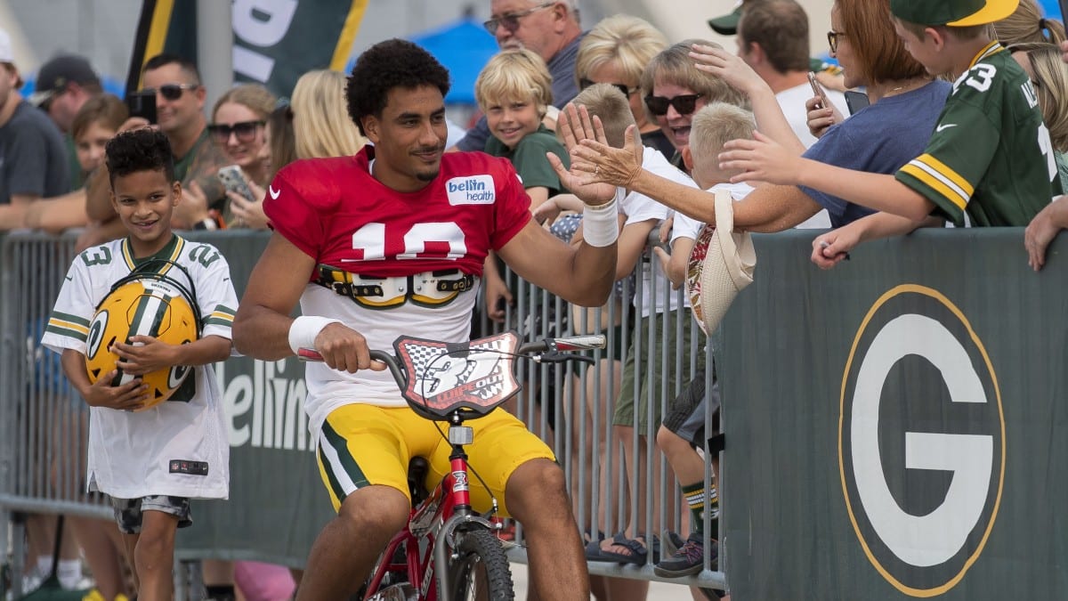 AJ Dillon of the Green Bay Packers rides a bike to training camp