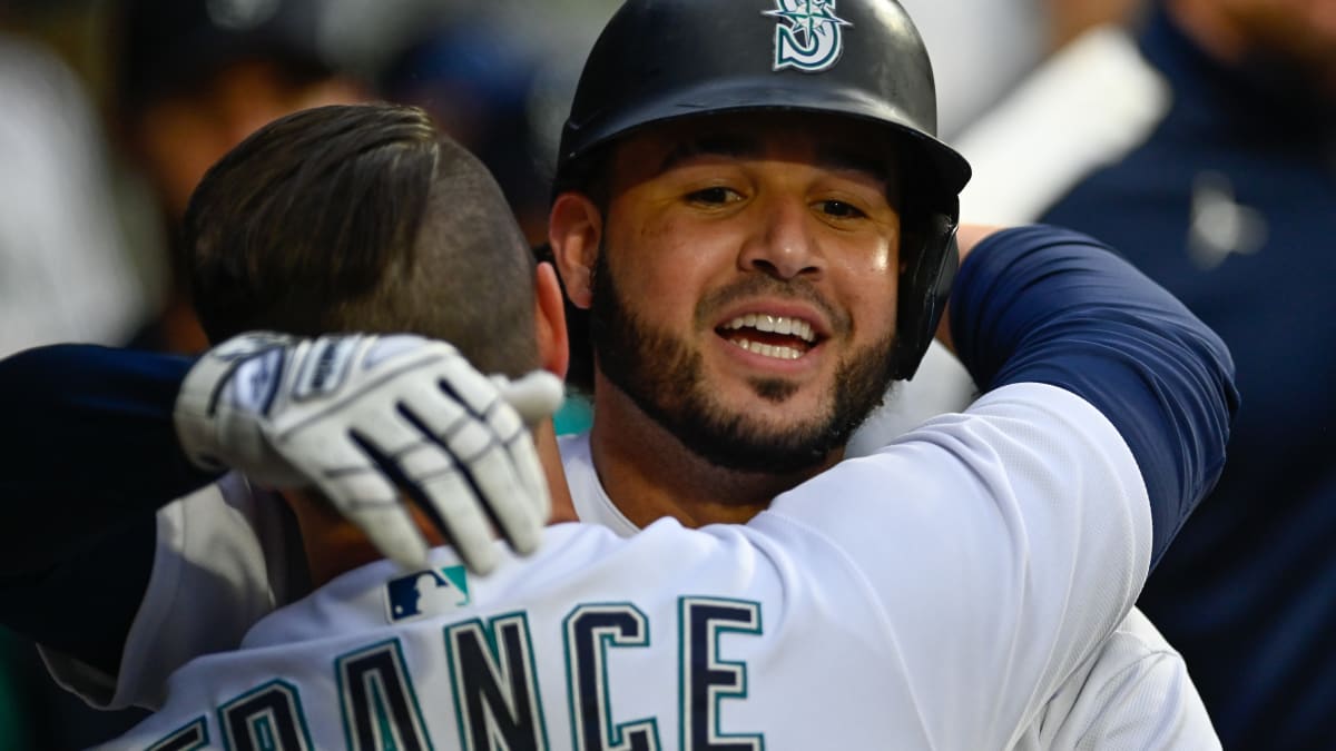 Seattle Mariners' Ty France holds his bat on his helmet after