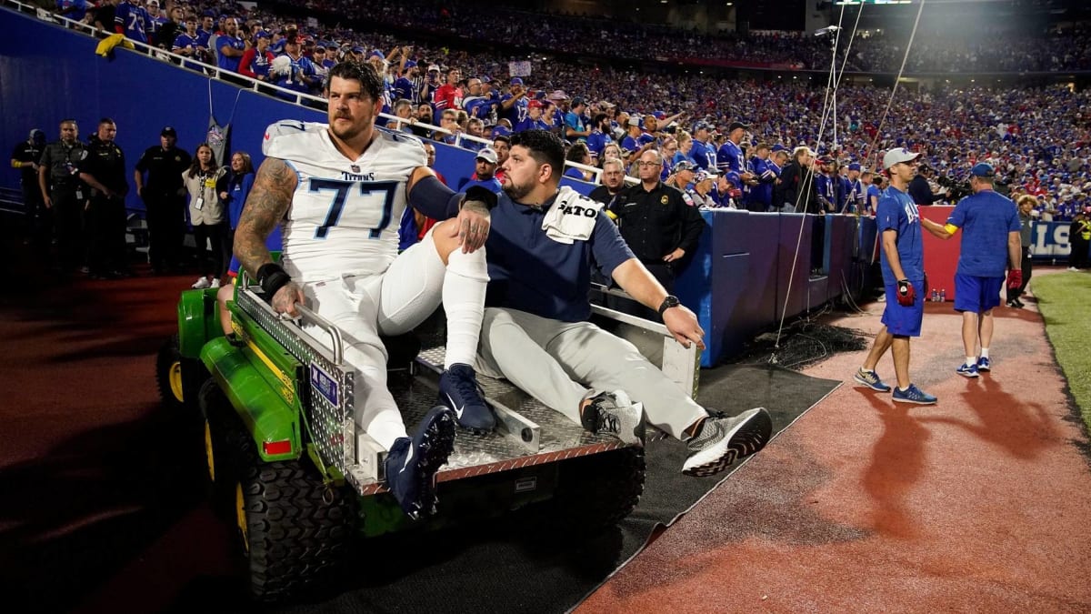 Tennessee Titans offensive tackle Taylor Lewan carries his daughter, Wynne,  1, as he leaves the field following the first day of practice at NFL  football training camp Thursday, July 26, 2018, in