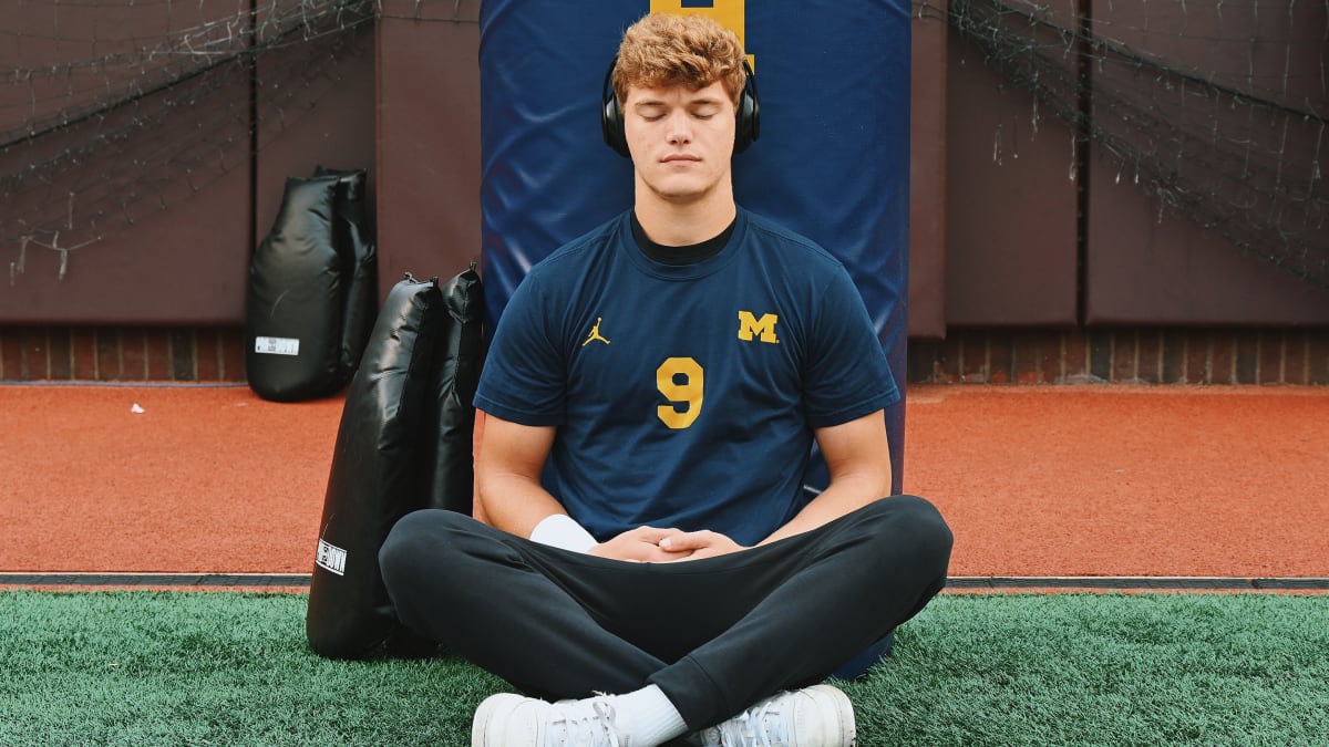 Michigan HC Jim Harbaugh and QB J.J. McCarthy talk to Allison