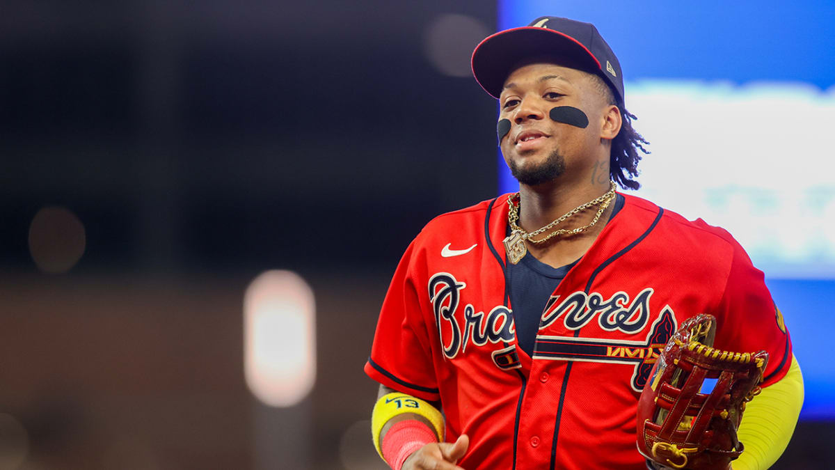 Atlanta Braves outfielder Ronald Acuña Jr. confronted by two fans who  stormed field midgame
