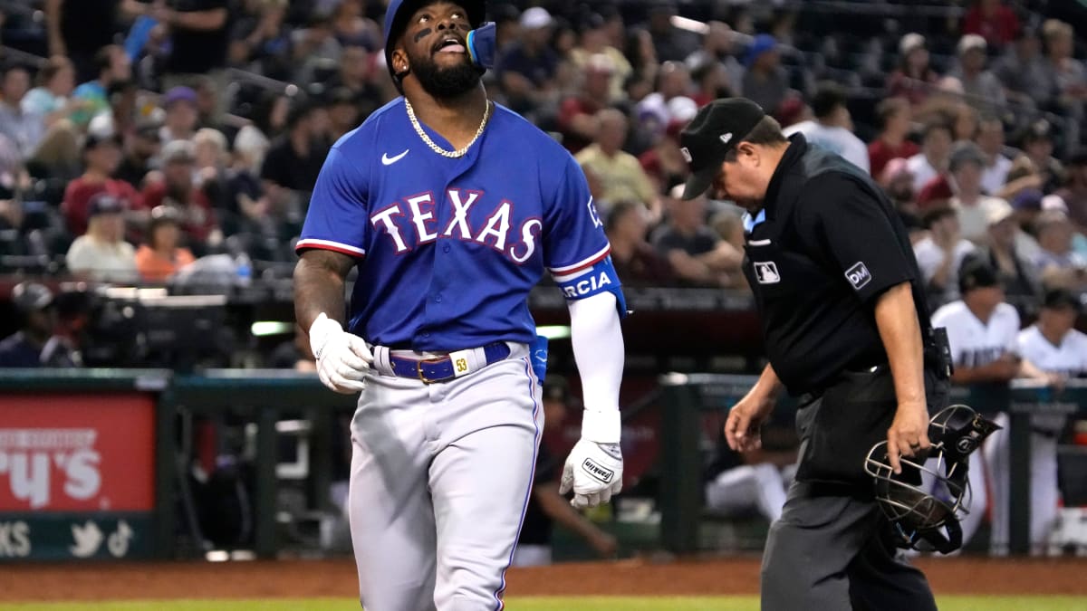 Adolis Garcia of the Texas Rangers fields a ball during the first