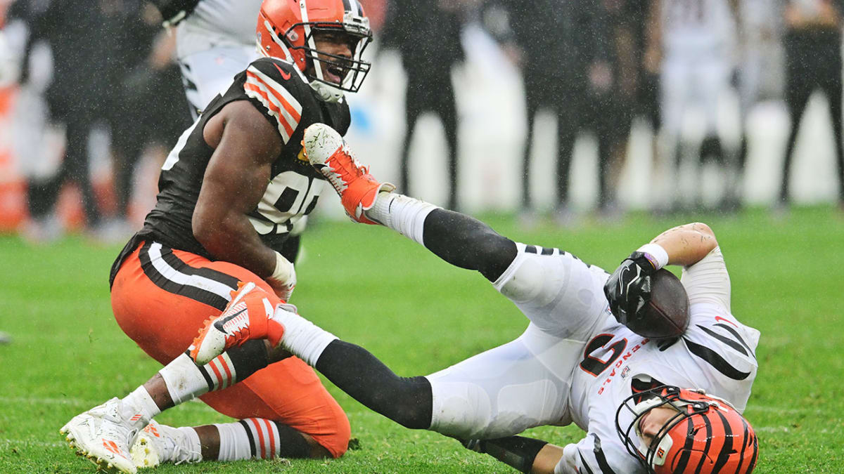 Cincinnati Bengals quarterback Joe Burrow (9) is pressured by and sacked by  Cleveland Browns defensive end