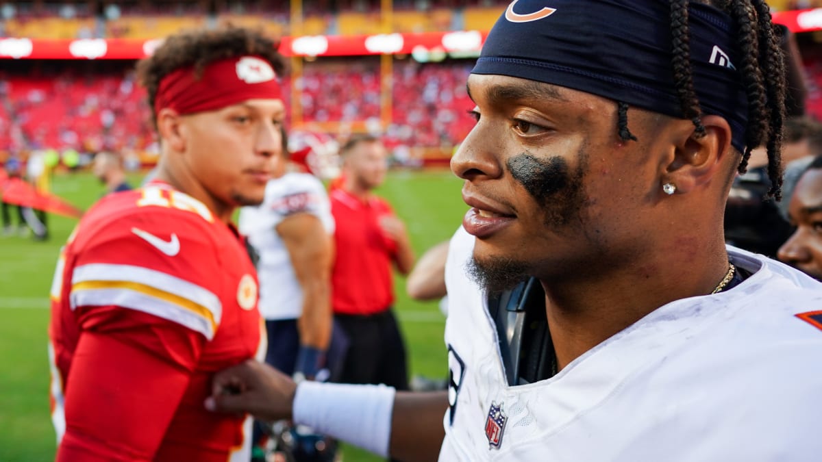 A Chicago Bears fan holds a quarterback Justin Fields jersey