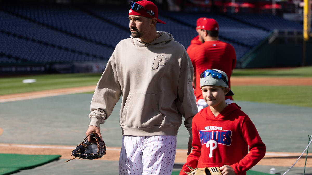 Philadelphia Phillies - Photo of Nick Castellanos and his son Liam arriving  at Citizens Bank Park. Nick is on the left wearing a tan colored hoodie  with a white shirt underneath. He