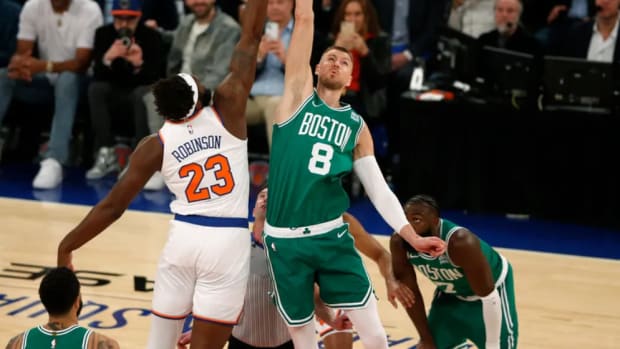 Kristaps Porzingis (8) makes Wednesday's opening tip-off against Mitchell Robinson