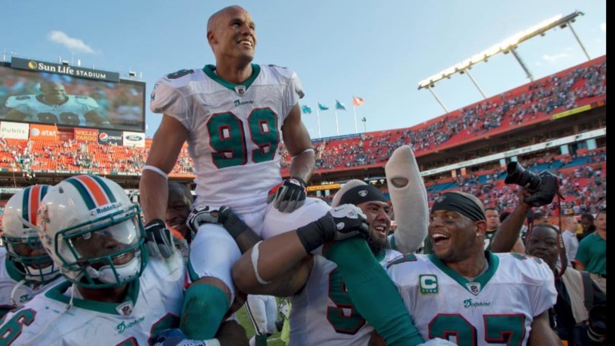 Charitybuzz: Miami Dolphin Legends Jason Taylor and Zach Thomas Signed  Football & Photograph