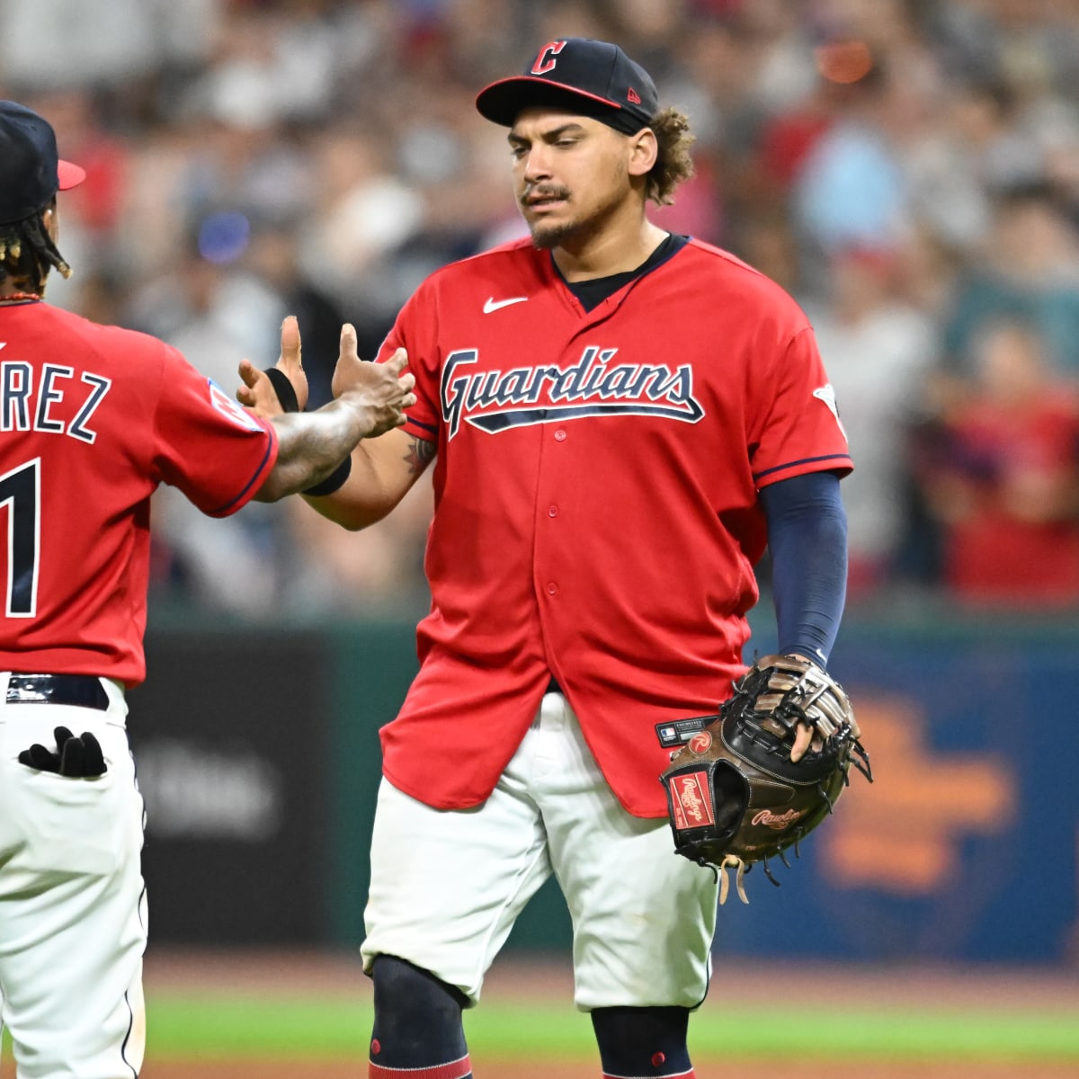 Cleveland Guardians' Josh Bell, left, and Jose Ramirez pose after