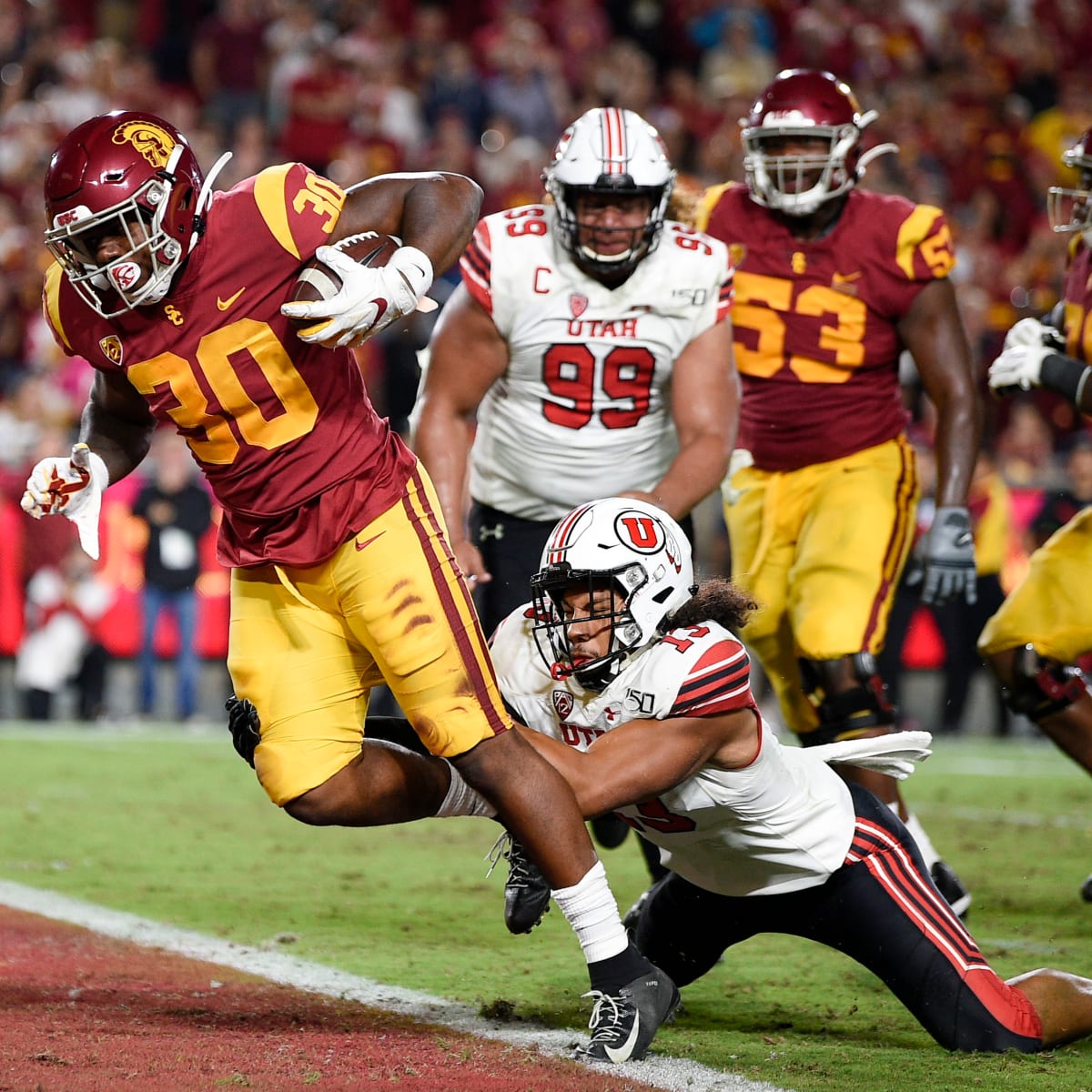 Running back Vavae Malepeai of the USC Trojans pushes through a