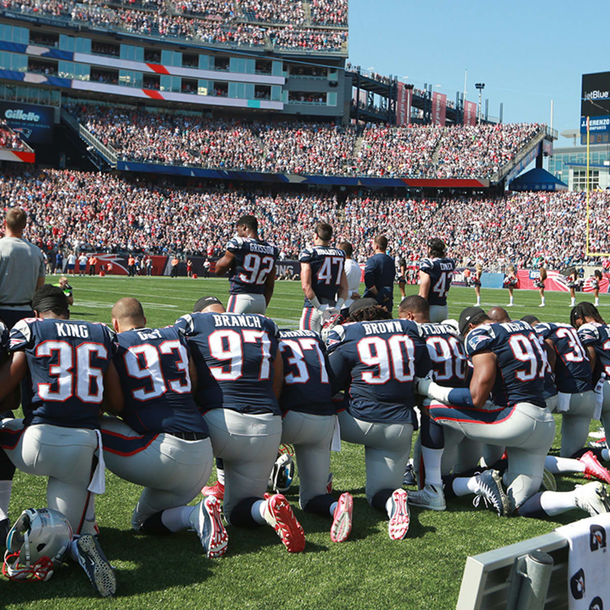 U.S military personnel stand of the field before an NFL football game  between the Arizona Cardinals