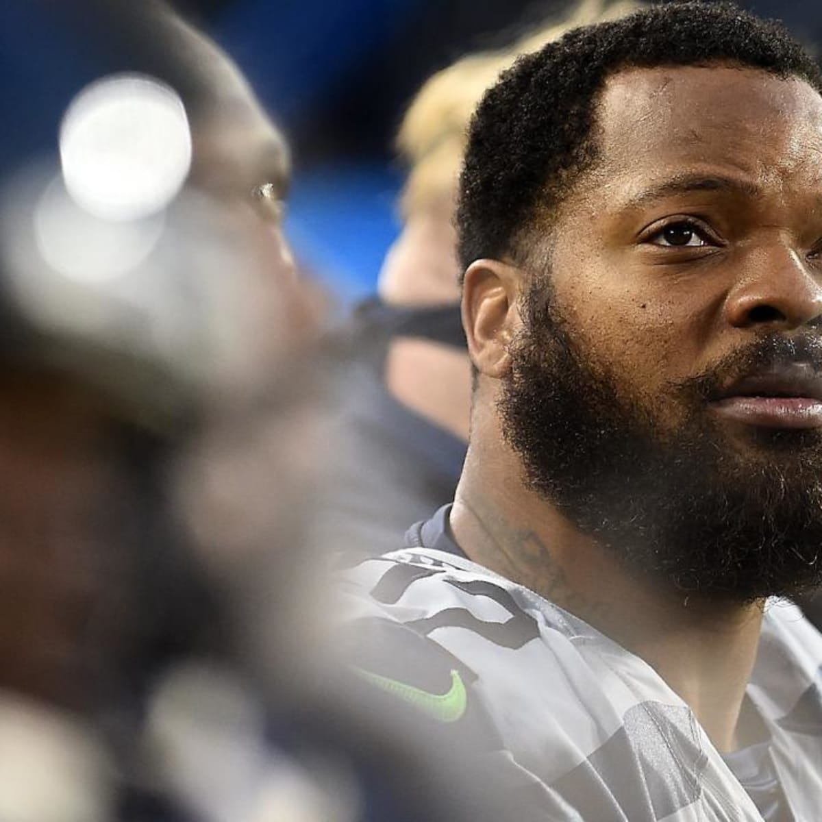 Michael Bennett, all Seahawks, stand for the national anthem on Salute to  Service night vs. Atlanta