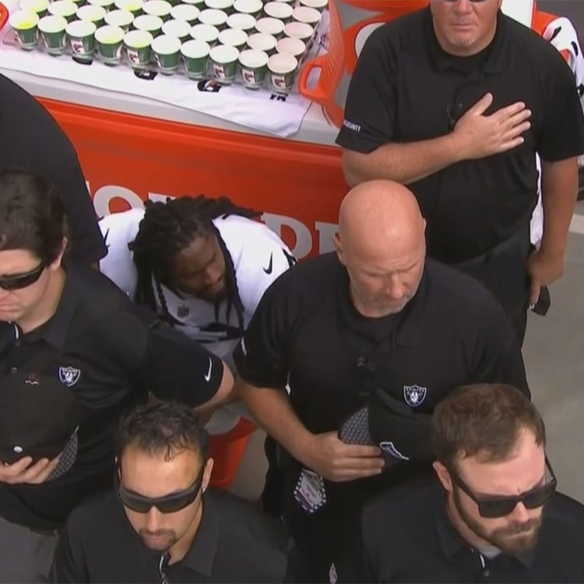 Raiders RB Marshawn Lynch sits during national anthem