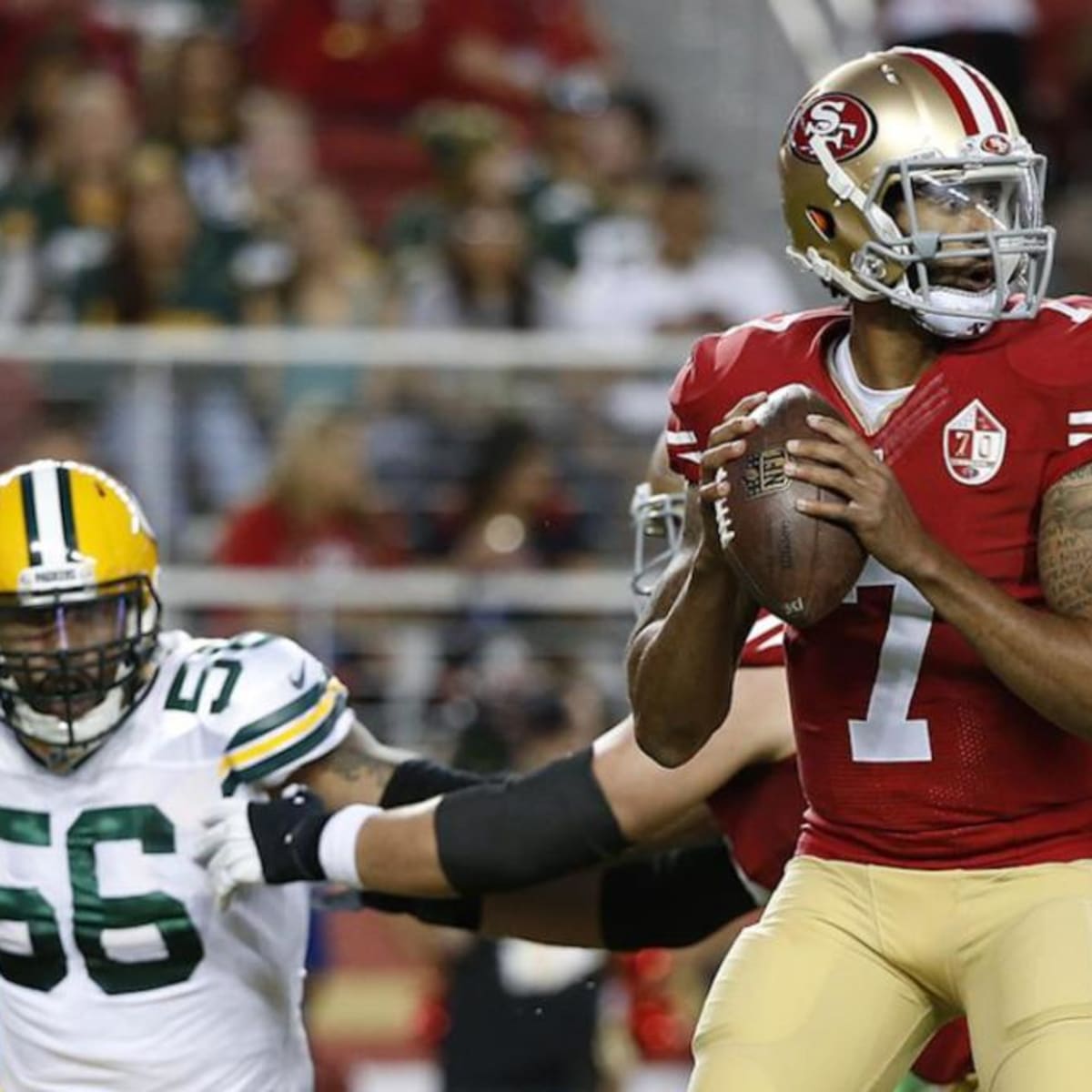 Colin Kaepernick of San Francisco 49ers sits during national