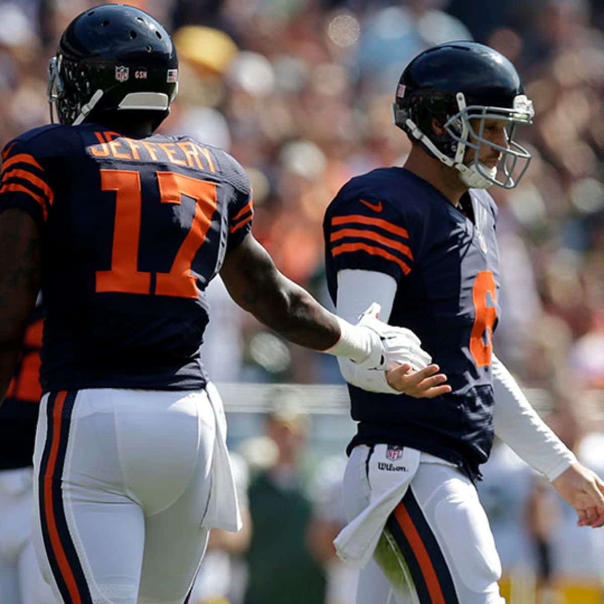 Chicago Bears quarterback Jay Cutler (R) talks with wide receiver