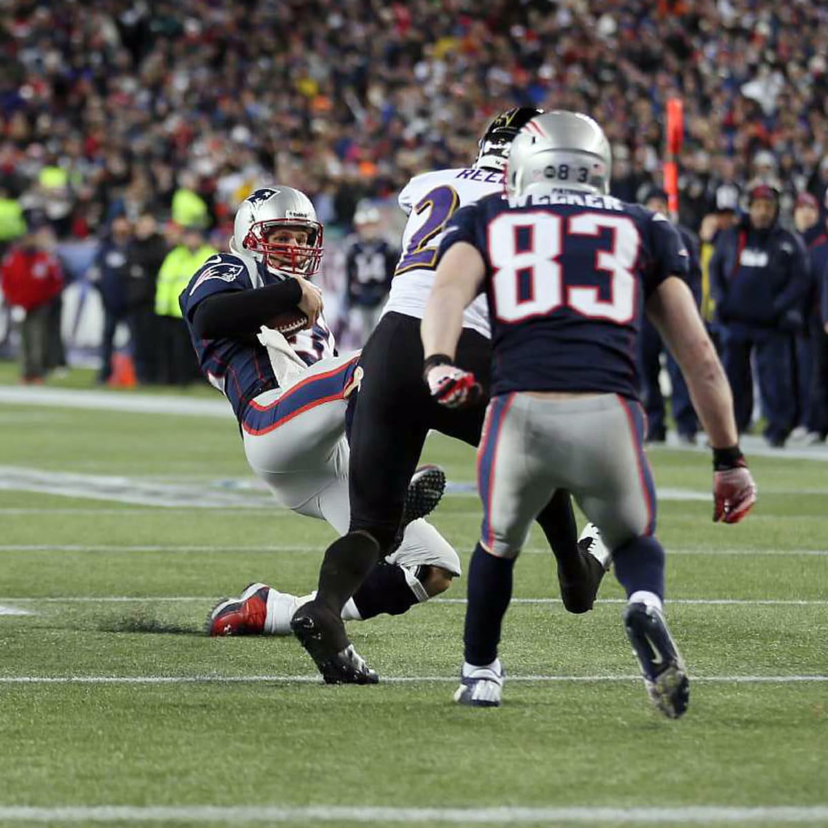 Tom Brady slides with cleats high