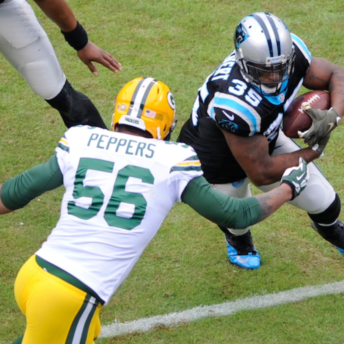 Green Bay Packers defensive tackle B.J. Raji blows kisses to fans