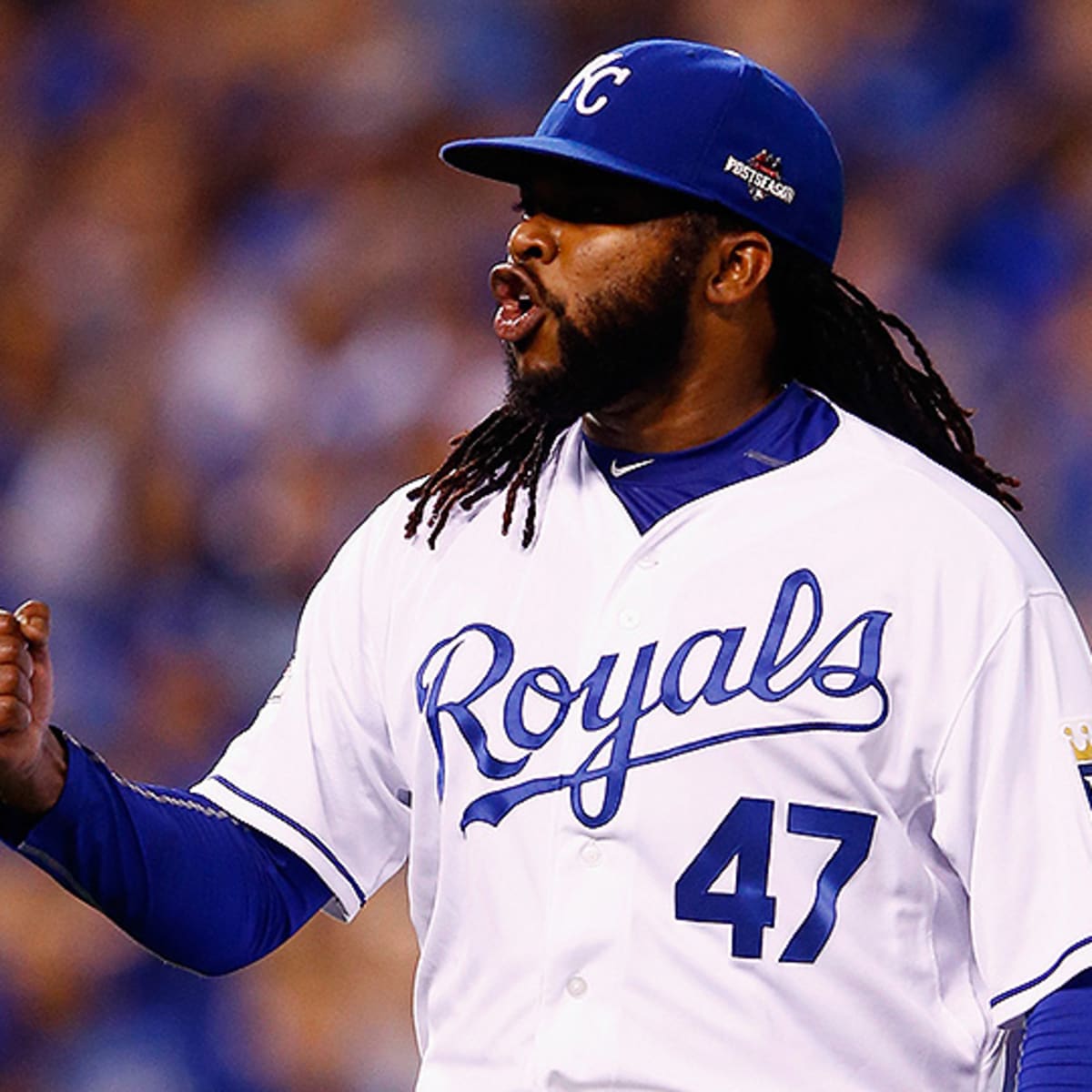 Kansas City Royals fans hold up pictures of starting pitcher Johnny Cueto  and catcher Salvador Perez as he Royals face the New York Mets in game 2 of  the World Series at