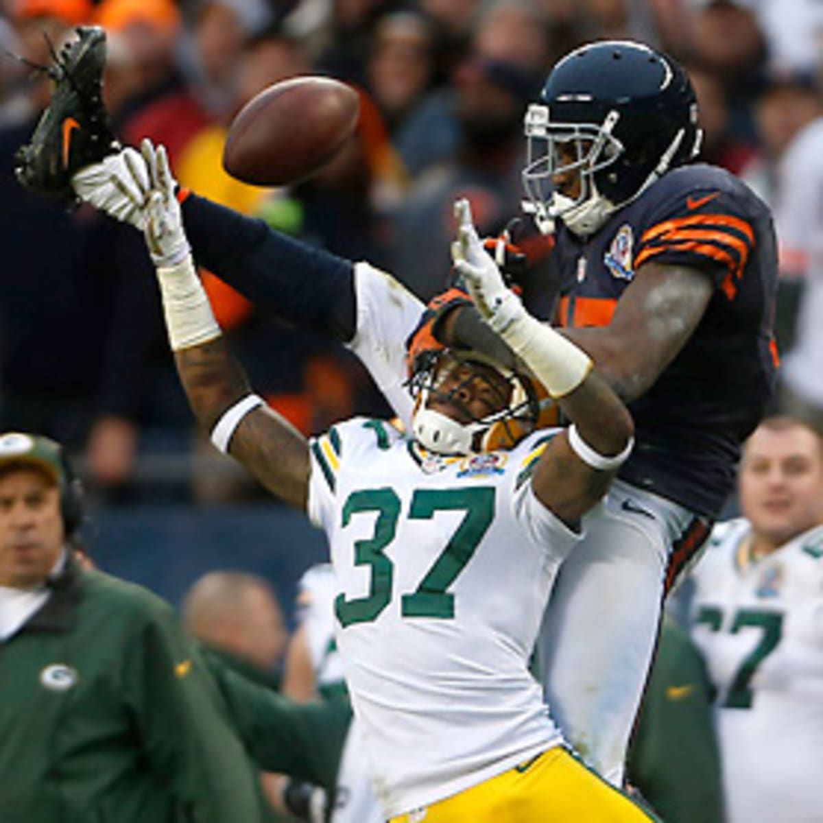 Flags fly as Chicago Bear wide receiver Alshon Jeffery makes a catch with  Green Bay Packer defensive back Sam Sheilds on the coverage in the first  half at Lambeau Field on Sunday