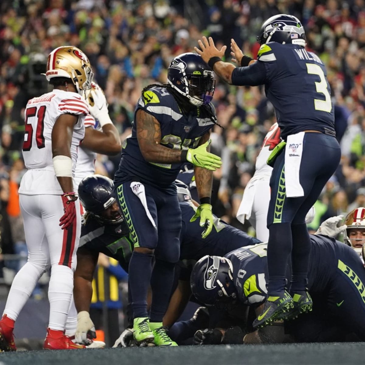 Seattle Seahawks running back Marshawn Lynch (24) dons his gloves during an  injury time out during the NFL Championship Game against the San Francisco  49ers at CenturyLink Field in Seattle, Washington on