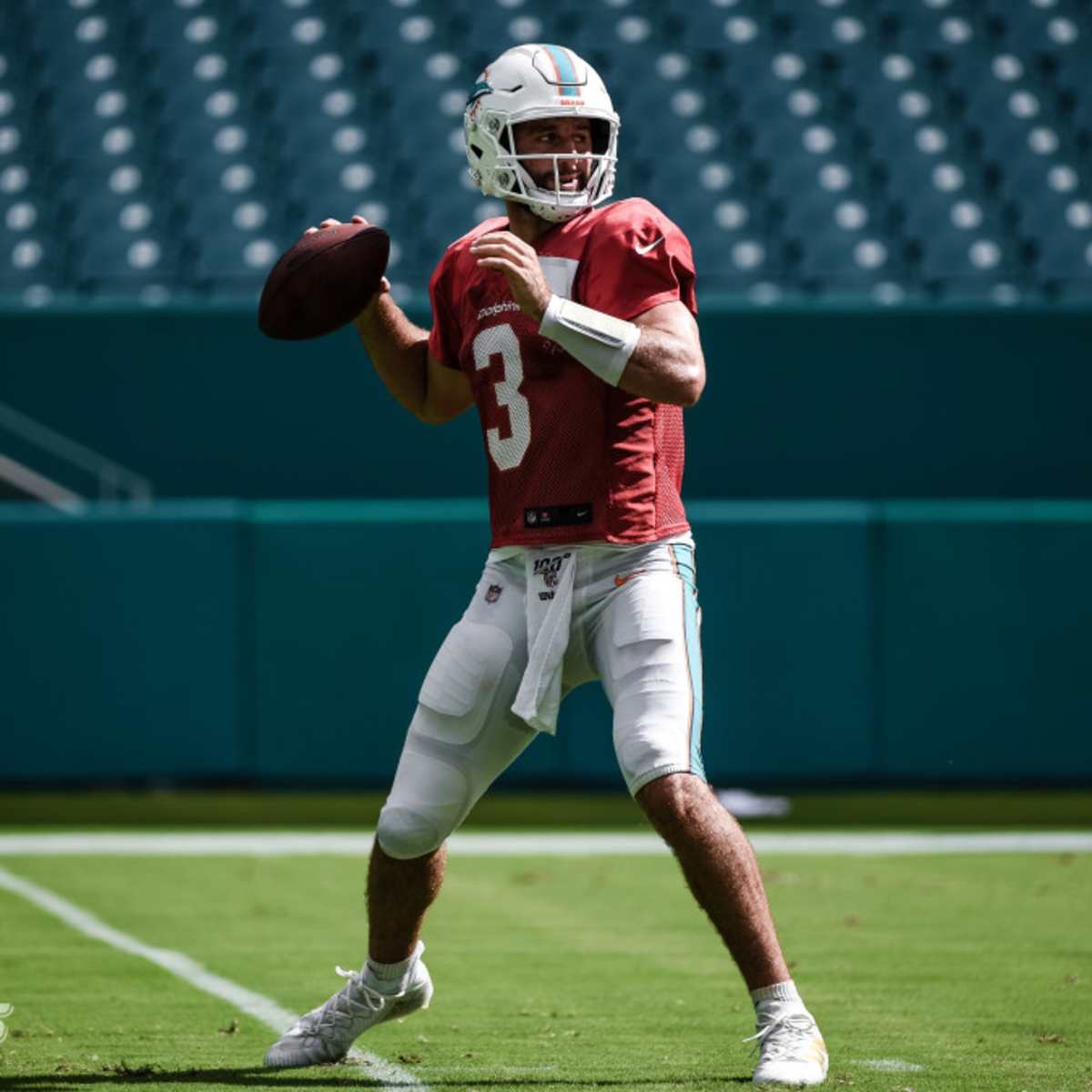 Miami Dolphins quarterback Josh Rosen takes off his socks after